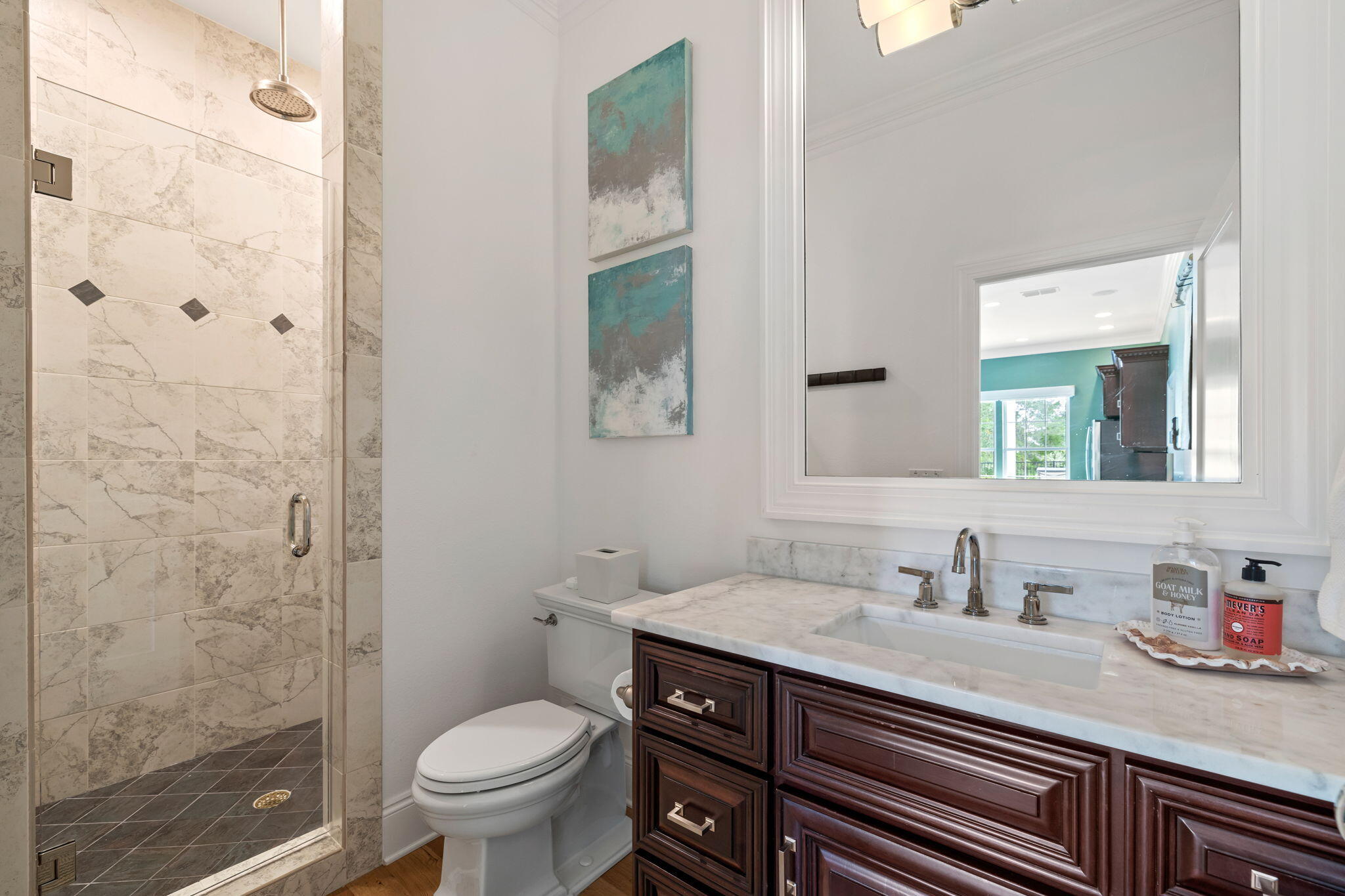 486 Coastal Breeze Drive Freeport, FL 32439 - Photo 40 of 70 a bathroom with a granite countertop toilet a sink and a mirror