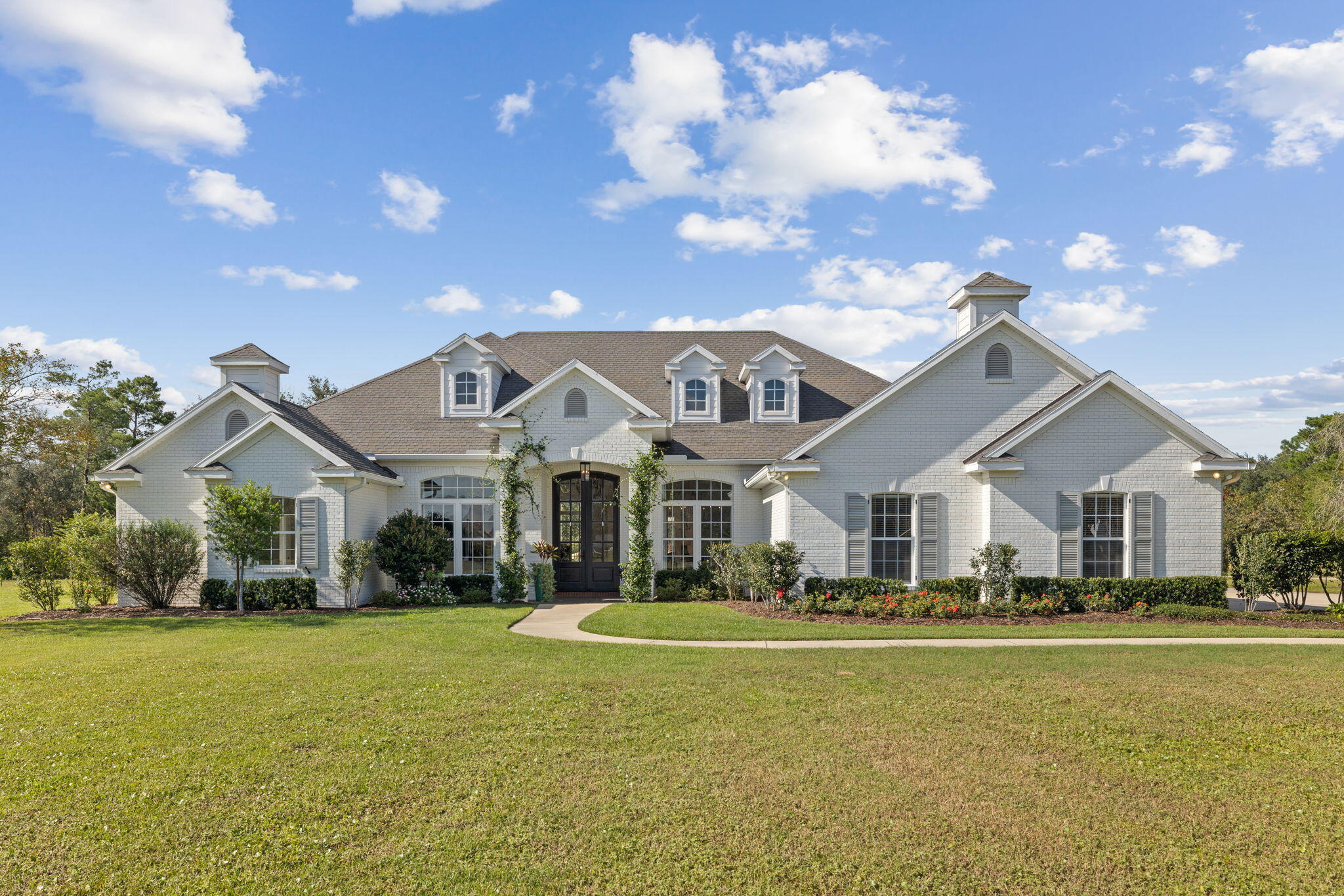 486 Coastal Breeze Drive Freeport, FL 32439 - Photo 52 of 70 a front view of a house with a garden