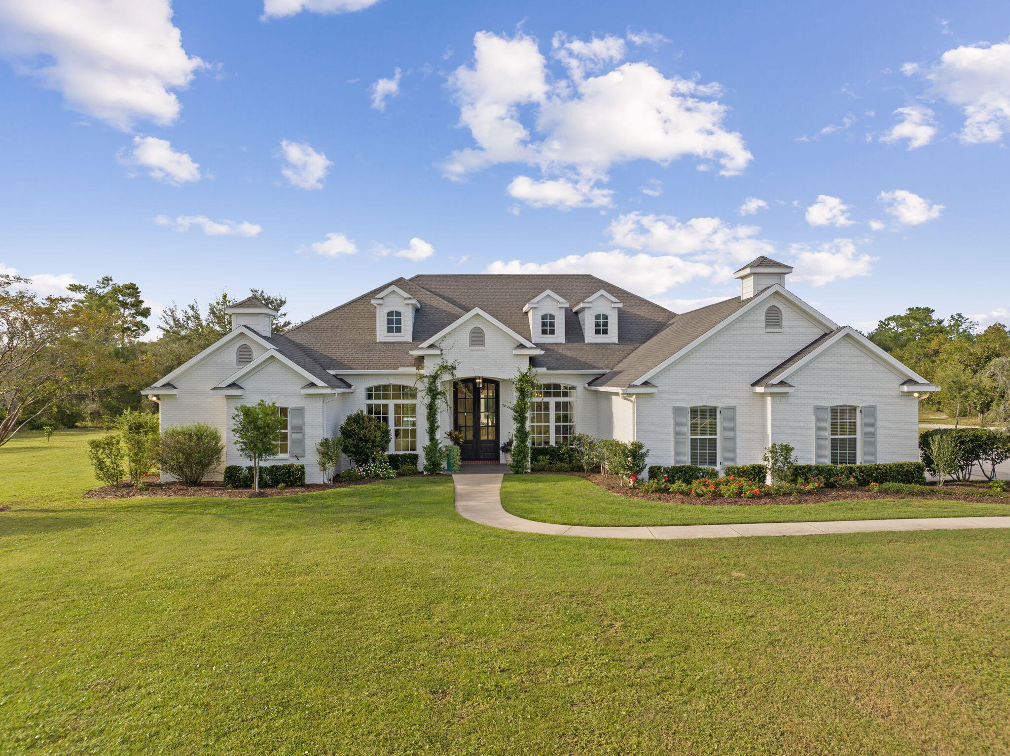 486 Coastal Breeze Drive Freeport, FL 32439 - Photo 62 of 70 a front view of a house with a garden