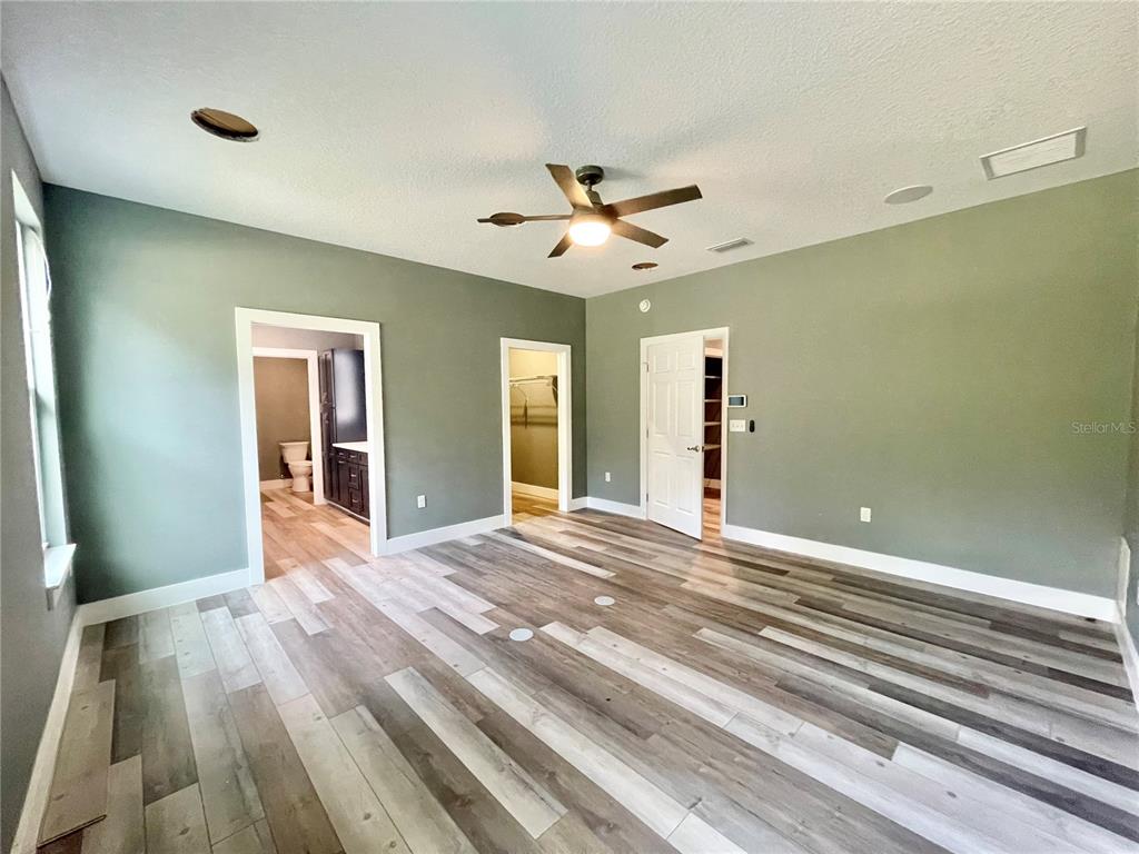 10620 Southwest 10th Terrace Micanopy, FL 32667 - Photo 14 of 58 a view of an empty room with wooden floor and a window