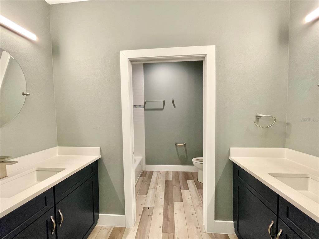 10620 Southwest 10th Terrace Micanopy, FL 32667 - Photo 25 of 58 a bathroom with a sink a mirror and a shower