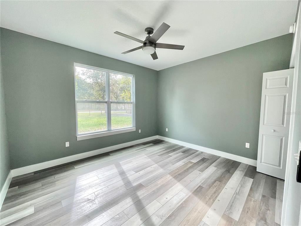 10620 Southwest 10th Terrace Micanopy, FL 32667 - Photo 30 of 58 a view of a livingroom with a ceiling fan and window