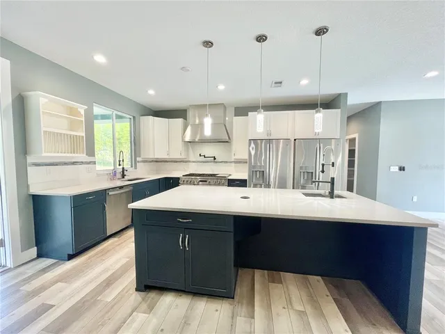 a kitchen with stainless steel appliances a stove and a refrigerator