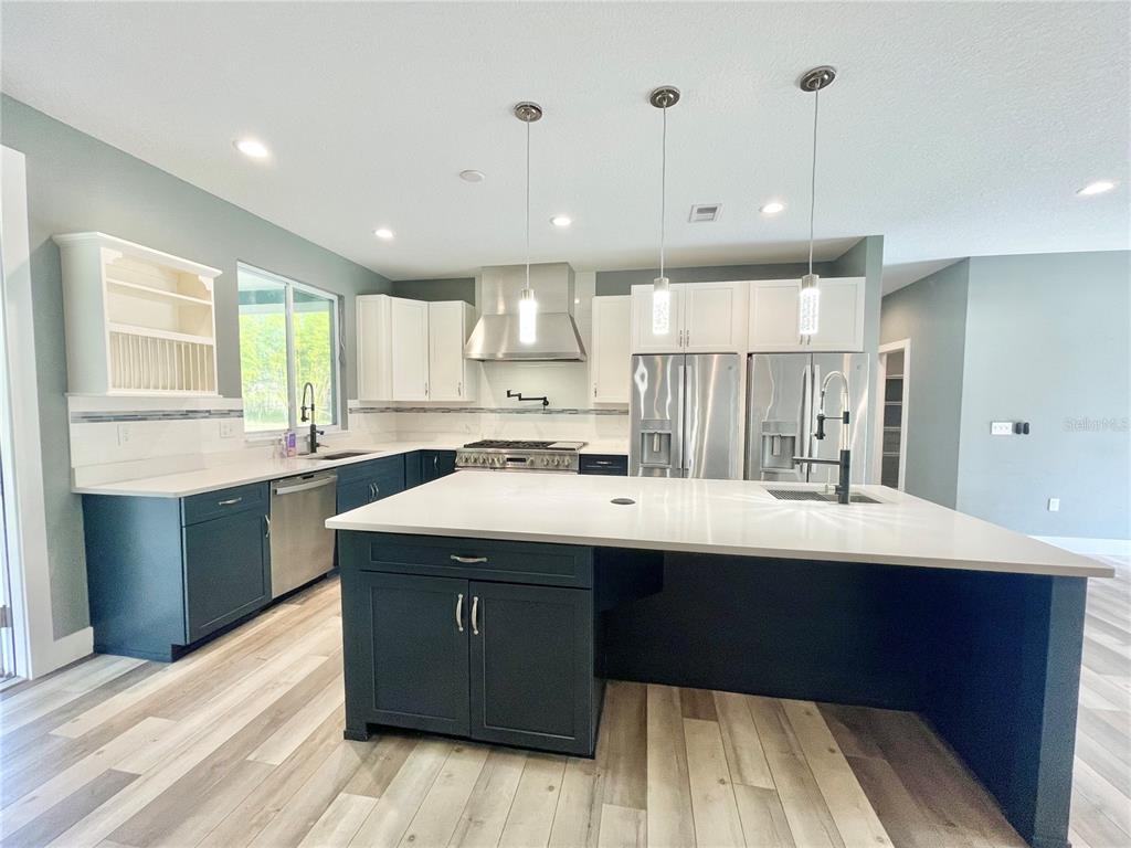10620 Southwest 10th Terrace Micanopy, FL 32667 - Photo 3 of 58 a kitchen with kitchen island a sink stainless steel appliances and cabinets