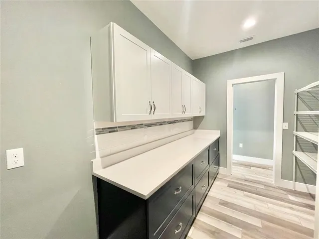 a kitchen with stainless steel appliances kitchen island granite countertop a refrigerator and a sink