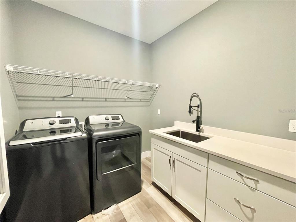 10620 Southwest 10th Terrace Micanopy, FL 32667 - Photo 36 of 58 a close view of a sink a stove and storage