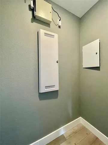 a view of a swimming pool with a bench and trees