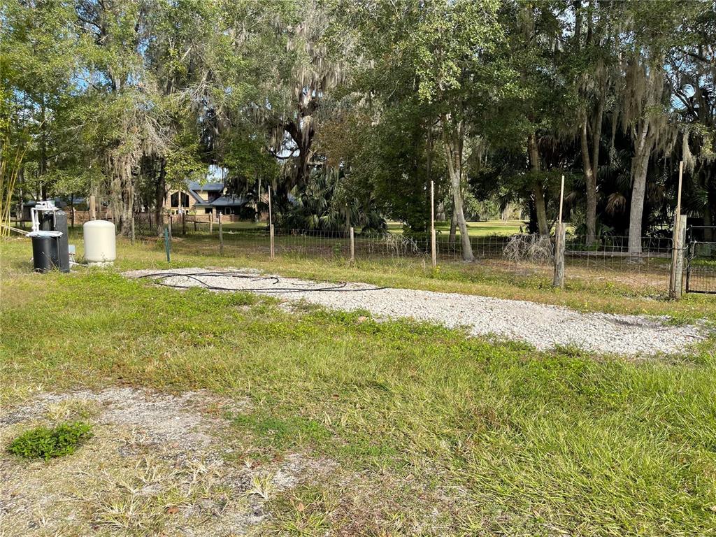 10620 Southwest 10th Terrace Micanopy, FL 32667 - Photo 48 of 58 a view of a swimming pool with a bench and trees