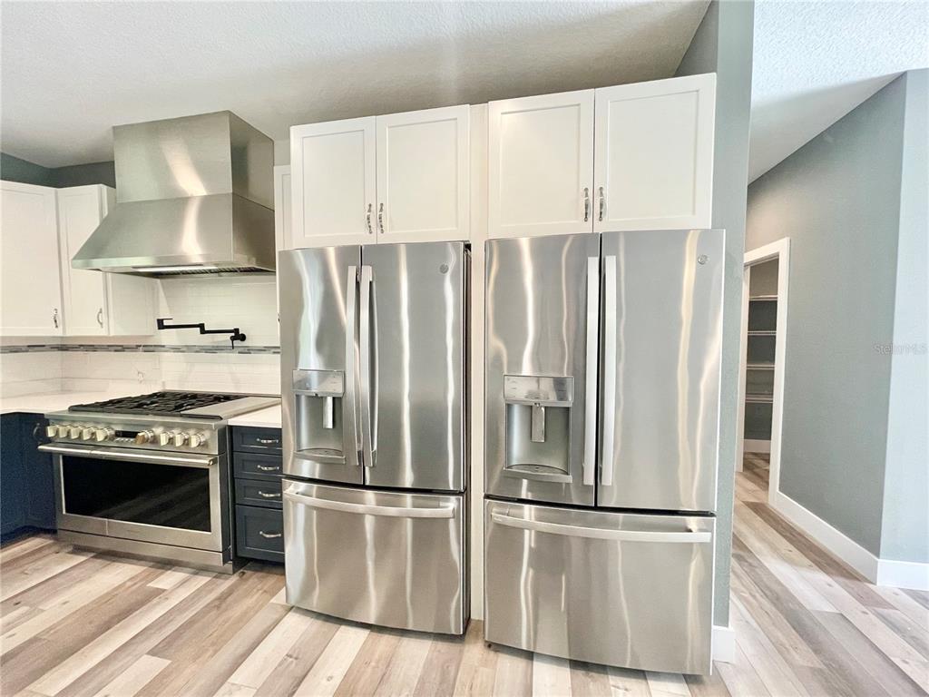 10620 Southwest 10th Terrace Micanopy, FL 32667 - Photo 5 of 58 a kitchen with stainless steel appliances a stove a refrigerator and cabinets