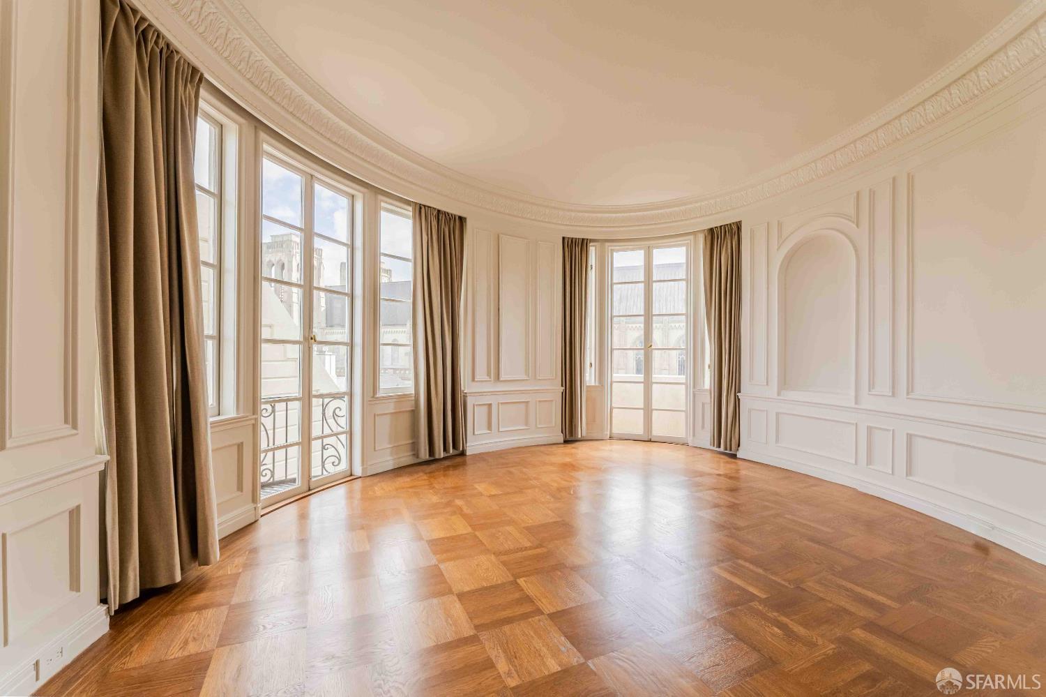 1298 Sacramento Street, Unit 6 San Francisco, CA 94108 - Photo 1 of 7 a view of an empty room with a window and wooden floor