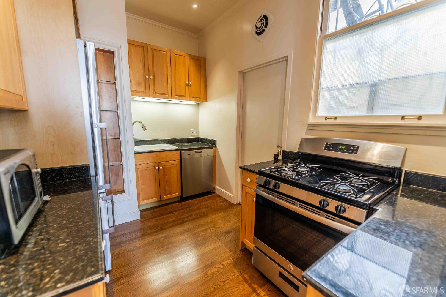 1298 Sacramento Street, Unit 6 San Francisco, CA 94108 - Photo 4 of 7 a kitchen with granite countertop a stove and a refrigerator