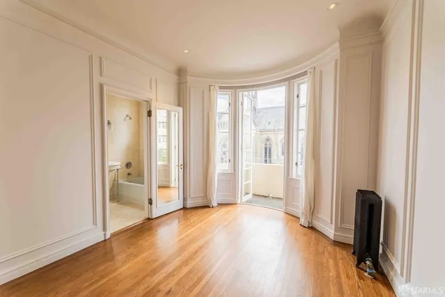 a view of a livingroom with wooden floor and a window