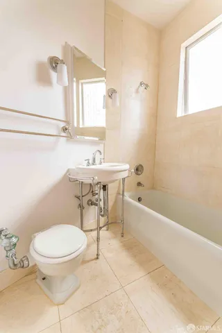 a bathroom with a toilet a sink and bathtub