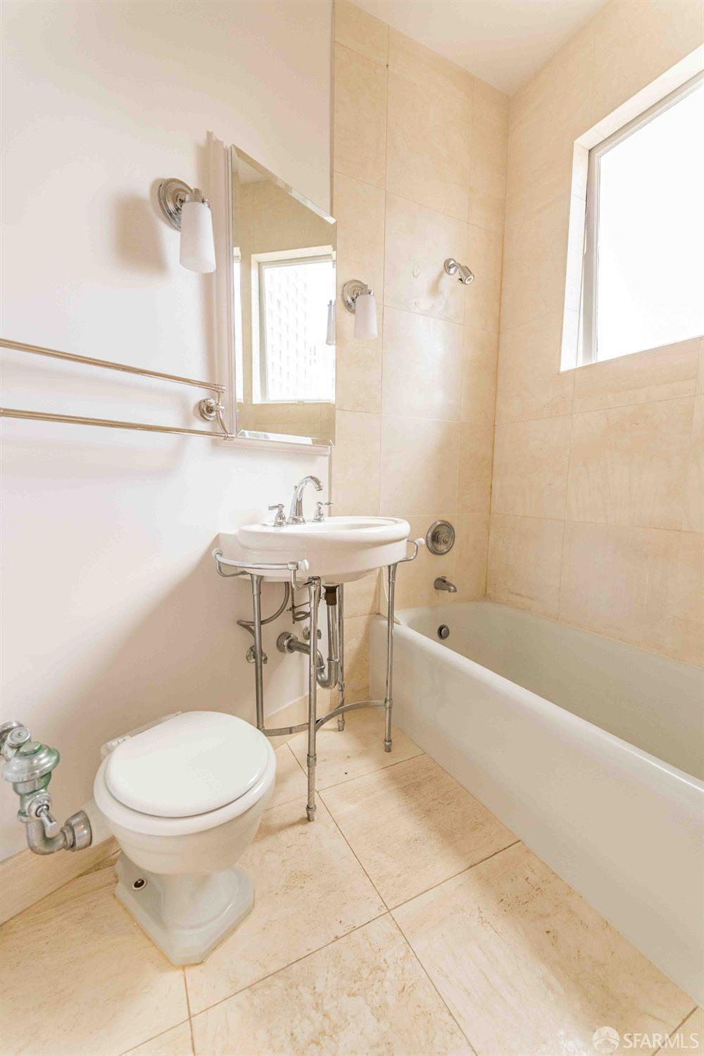 1298 Sacramento Street, Unit 6 San Francisco, CA 94108 - Photo 7 of 7 a bathroom with a toilet a sink and bathtub