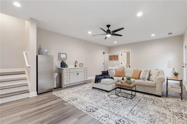a living room with furniture and wooden floor