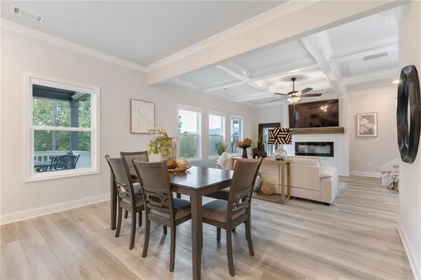 a view of a dining room with furniture window and wooden floor