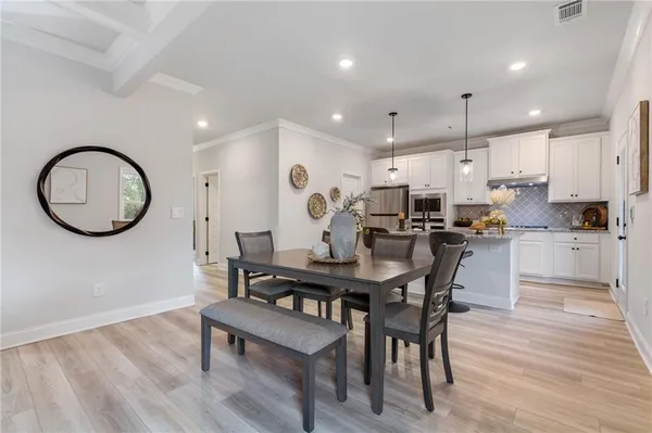 a view of a dining room with furniture and wooden floor