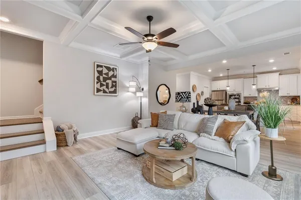a living room with furniture and a chandelier