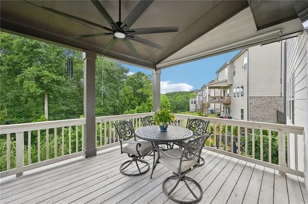 a view of a balcony with furniture and wooden floor