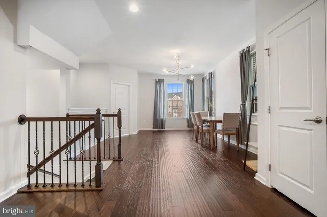 a view of a livingroom with furniture hardwood floor and hallway