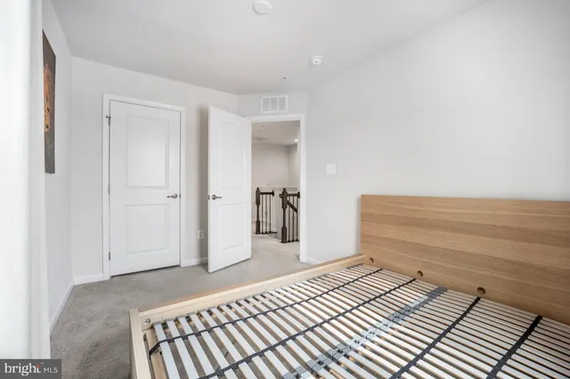 a bedroom with a bed and a view of bathroom