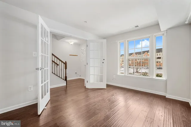 wooden floor in an empty room with a window