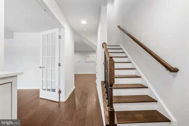 a view of entryway with wooden floor and stairs