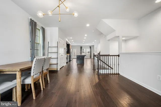 a view of a dining room with furniture wooden floor and chandelier