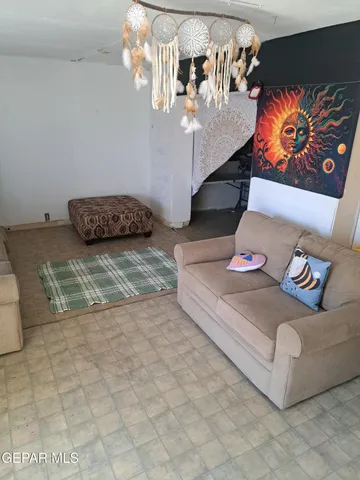 a living room with furniture and painting on the wall