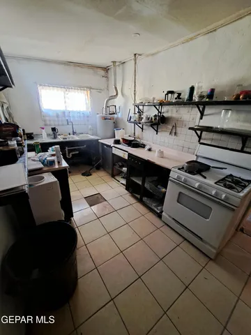 a kitchen with stainless steel appliances a stove a sink and a refrigerator