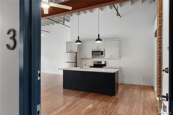 a kitchen with stainless steel appliances a sink and stove top oven