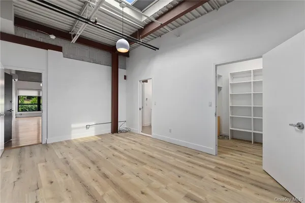 an empty room with wooden floor and a window