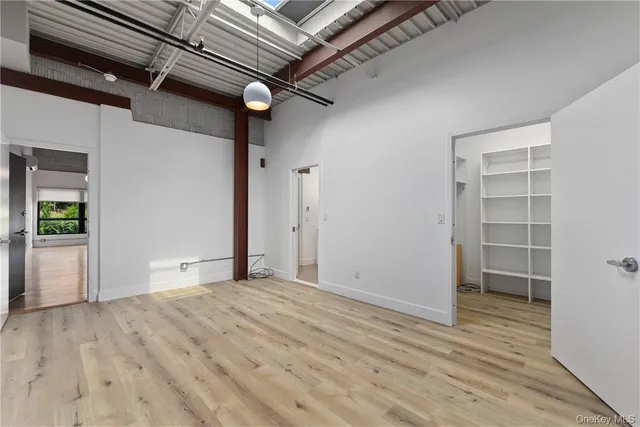 an empty room with wooden floor and a window