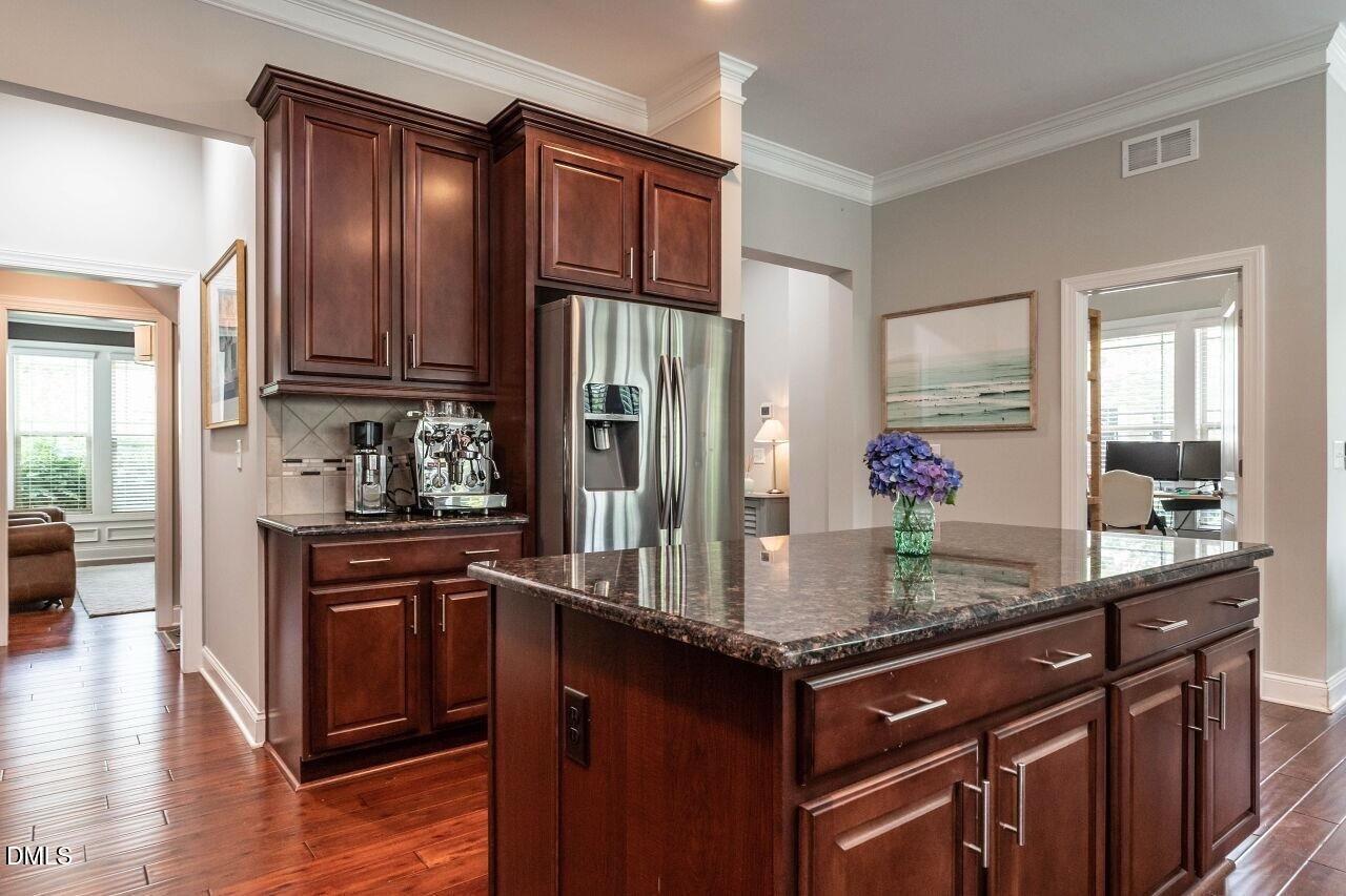 1572 Rodessa Run Raleigh, NC 27607 - Photo 12 of 39 a kitchen with granite countertop stainless steel appliances a sink refrigerator and cabinets