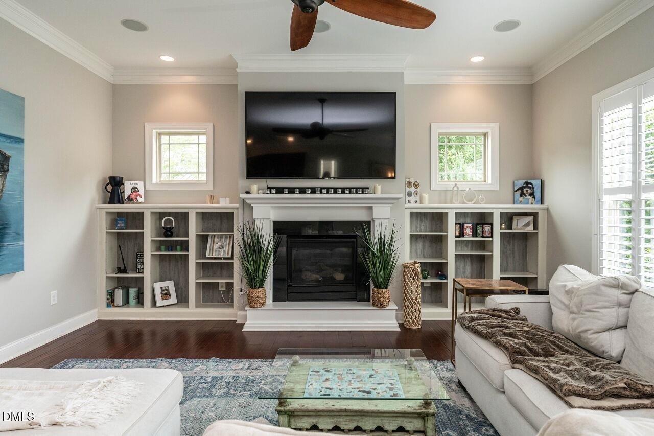 1572 Rodessa Run Raleigh, NC 27607 - Photo 14 of 39 a living room with furniture a flat screen tv and a fireplace
