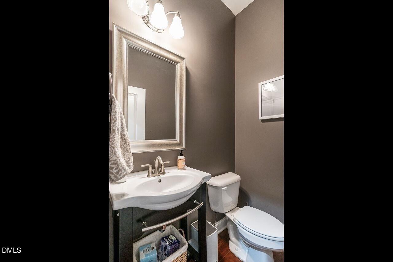 1572 Rodessa Run Raleigh, NC 27607 - Photo 18 of 39 a bathroom with a sink toilet and mirror