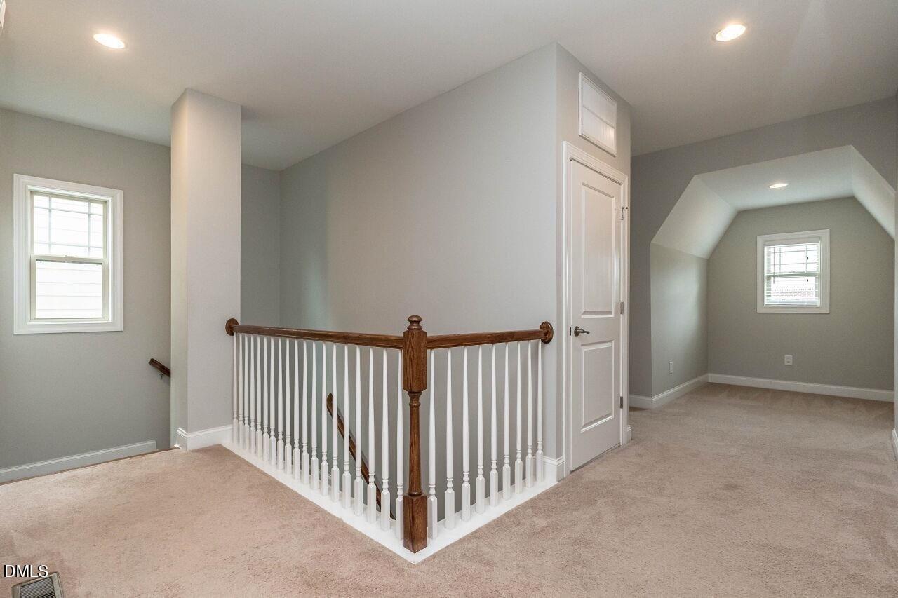 1572 Rodessa Run Raleigh, NC 27607 - Photo 19 of 39 a view of a hallway with windows