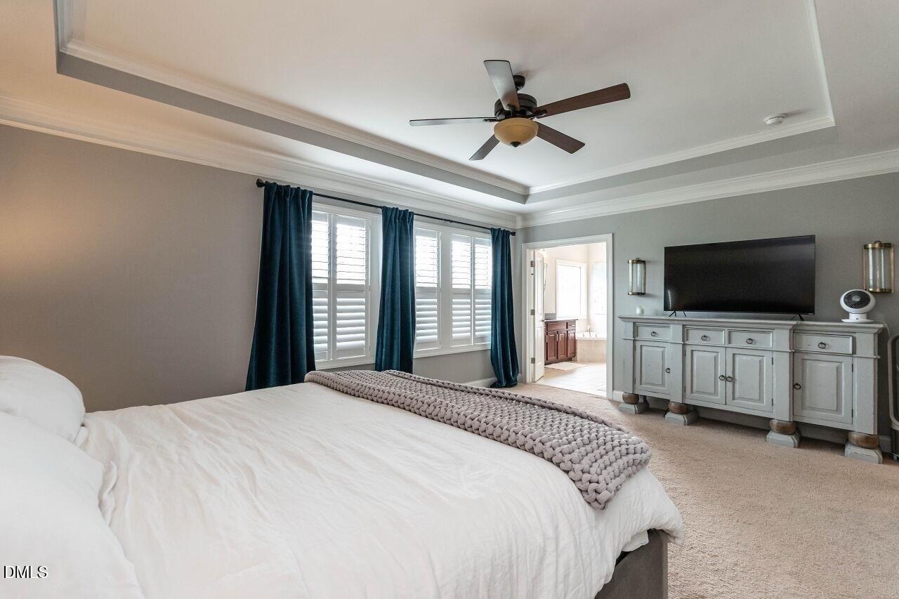 1572 Rodessa Run Raleigh, NC 27607 - Photo 22 of 39 a bedroom with a bed tv and a window