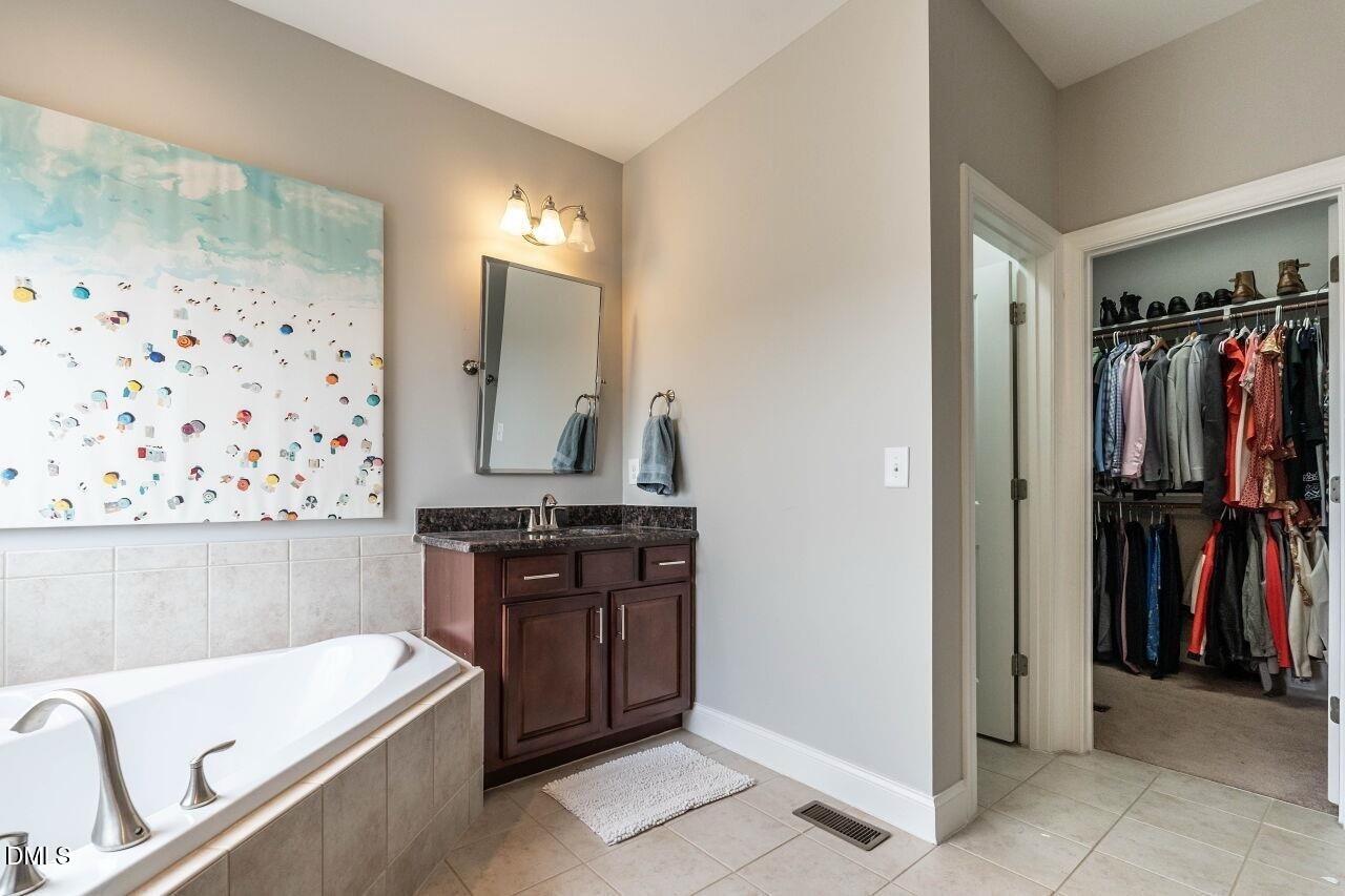 1572 Rodessa Run Raleigh, NC 27607 - Photo 25 of 39 a bathroom with a tub sink and a mirror