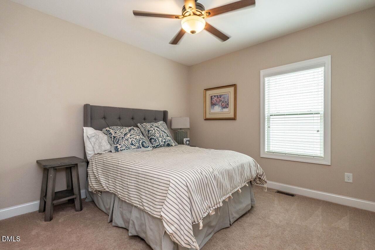 1572 Rodessa Run Raleigh, NC 27607 - Photo 28 of 39 a bedroom with a bed and a window