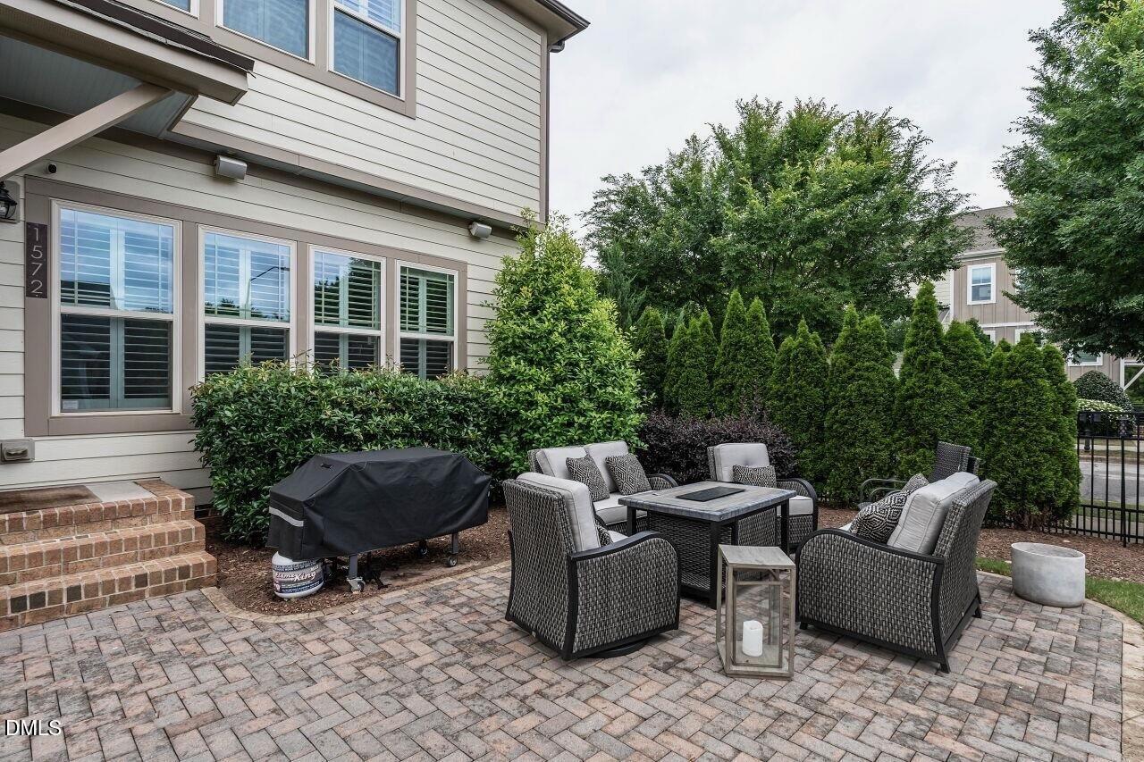 1572 Rodessa Run Raleigh, NC 27607 - Photo 32 of 39 a view of a patio with couches and a table and chairs with wooden fence