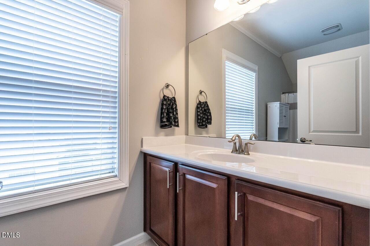 1572 Rodessa Run Raleigh, NC 27607 - Photo 36 of 39 a bathroom with a sink and a mirror