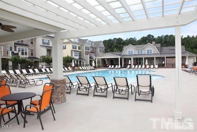 1572 Rodessa Run Raleigh, NC 27607 - Photo 37 of 39 a view of a patio with dining table and chairs with couches and wooden fence