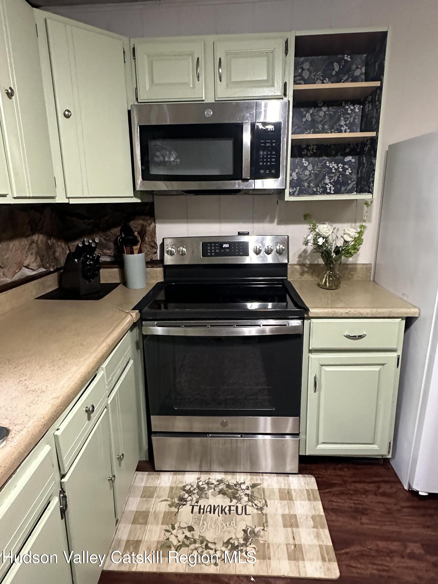 1640 Co Rte 13 Brainard, NY 12024 - Photo 8 of 23 a kitchen with a stove and a microwave