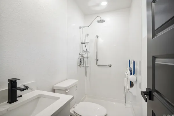 a bathroom with a toilet and a shower