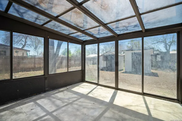 a view of empty room with large windows
