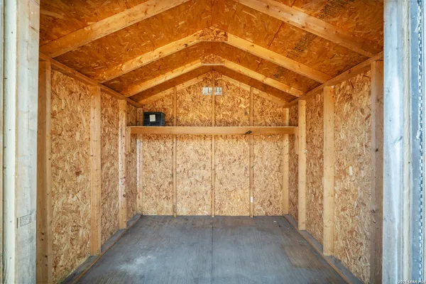 a view of a hallway with wooden door