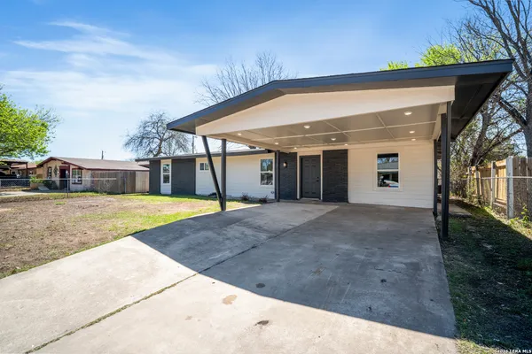 a view of a house with a backyard and a garage