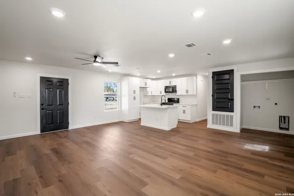 a view of a kitchen with a sink and a refrigerator