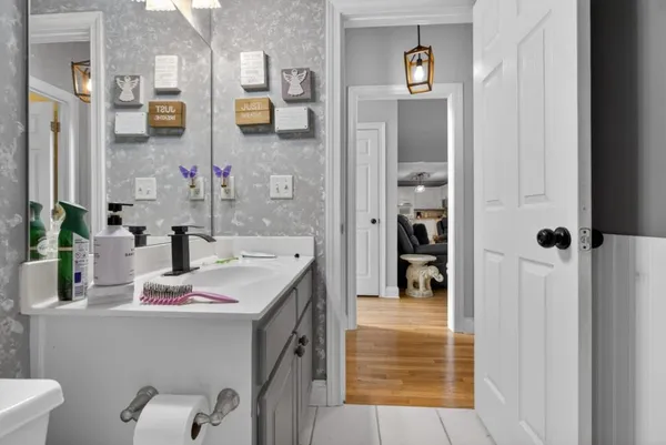 a spacious bathroom with a sink a toilet and a mirror